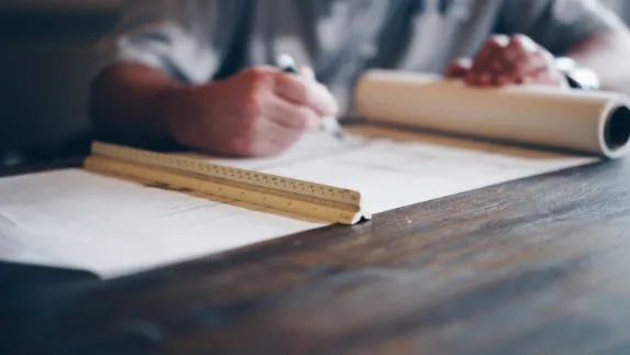 Man drafting up architectural plans